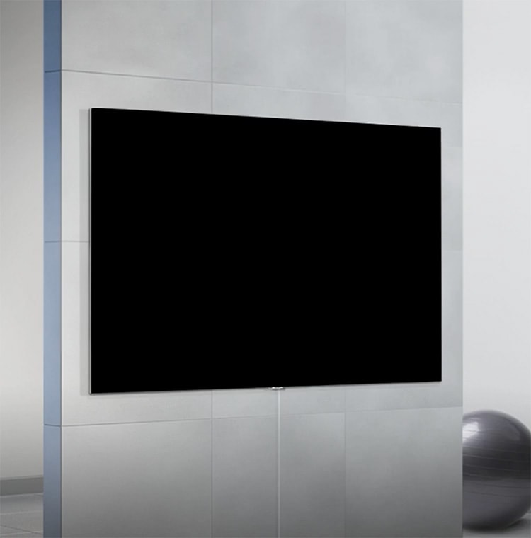 Image of TV mounted on wall with exercise ball on the floor