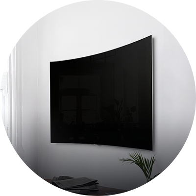 QLED TV is tightly close to the wall and hanging on it.