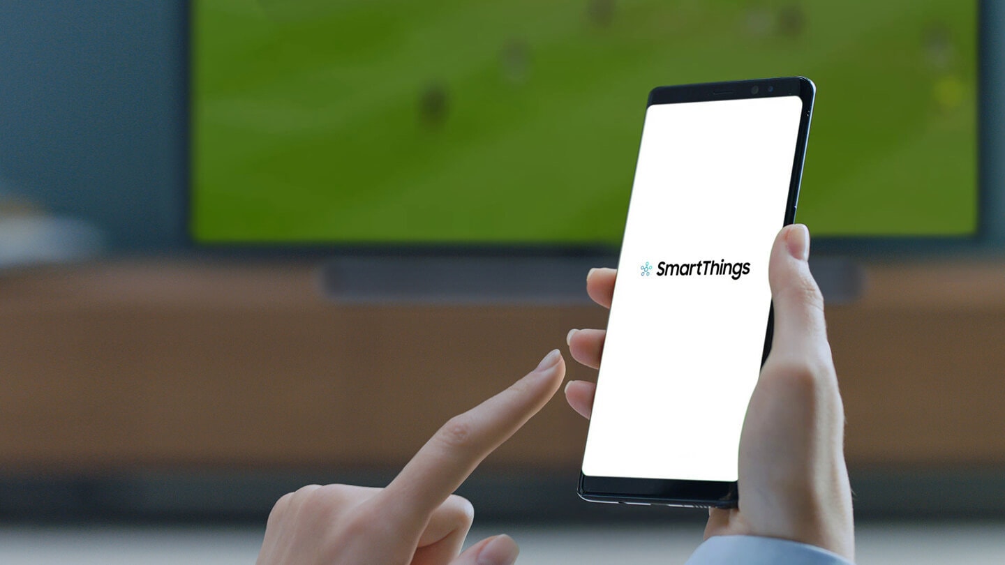 SmartThings app is loading on a mobile, and a finger is going to touch the screen.