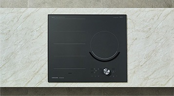 대리석으로 된 조리대 위에 전기레인지가 빌트인 방식으로 설치되어 있으며 이를 위에서 정면으로 내려다본 모습입니다.