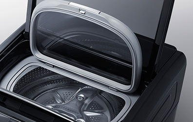 Samsung FlexWash Combo Washing Machine – 5. A frontal view of the FlexWash machine, with its upper washer door open, installed in a laundry room.