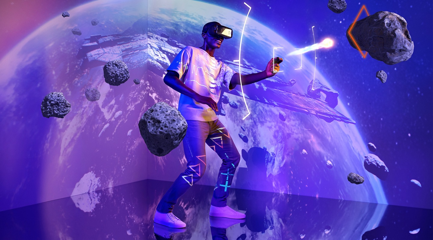 A man wearing a VR headset playing VR games in a backgroud setting of space with earth and a spaceship in the frame.