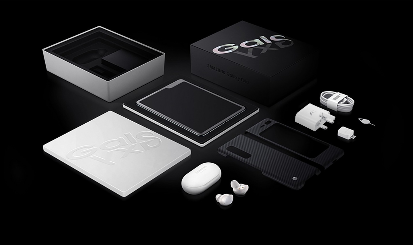 Flat lay photo of the Galaxy Fold box with Galaxy Fold. Below is the included Slim Cover, Galaxy Buds, Data Cable, Travel Adapter, Ejection Pin, and USB connector.