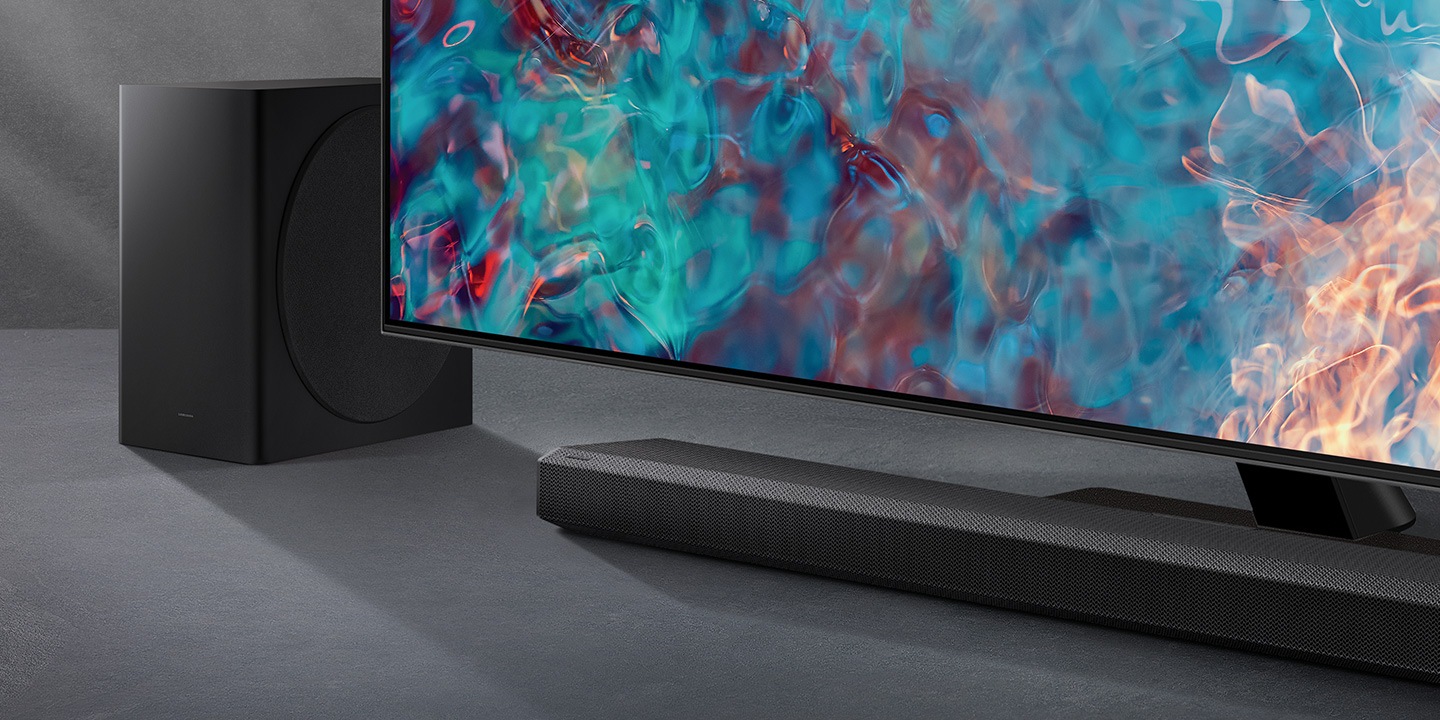 Q800A Soundbar and subwoofer are positioned next to QLED TV.