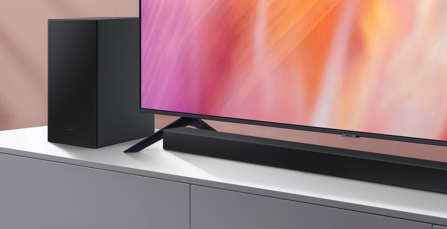 A series Soundbar and subwoofer are positioned next to Crystal UHD TV.