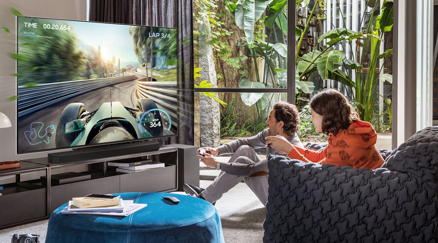 Two friends are enjoying an immersive gaming experience with Samsung Soundbar Game Mode Pro.