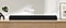 Apple AirPlay logo and Alexa Built-in logo can be seen along with Samsung S60A soundbar which is sitting on living room cabinet.
