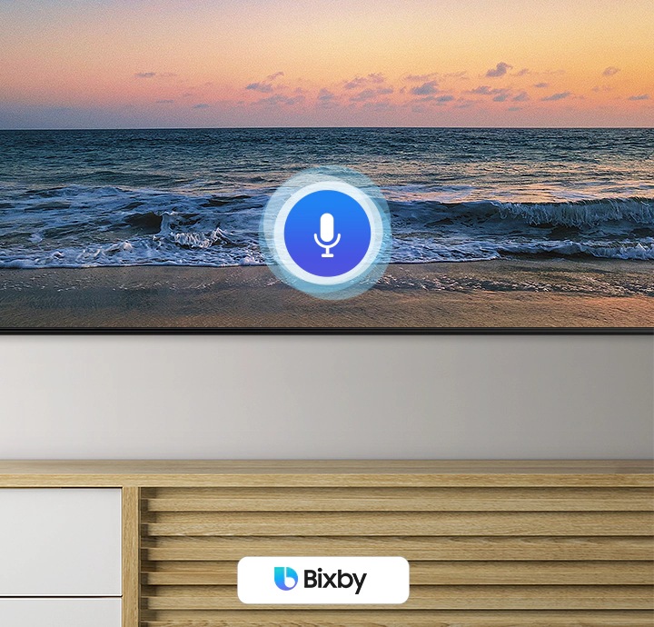 A microphone icon overlays an image, demonstrating voice assistant feature. The Bixby, Alexa built-in and the Hey Google logos are on display on the bottom.