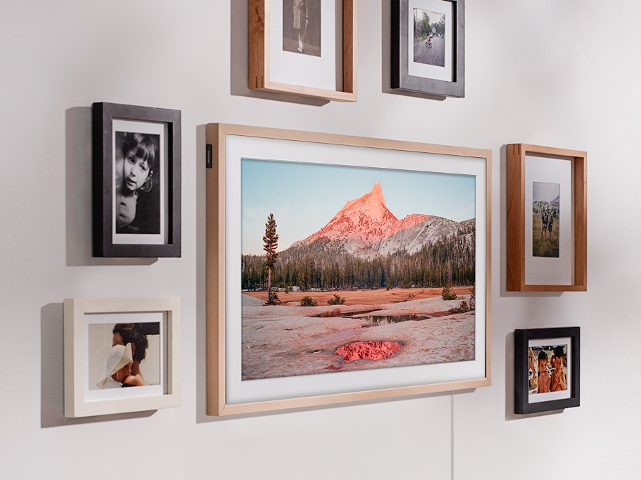 The Frame is hanging on a wall via a Slim Fit Wall Mount to look like a real picture frame. 