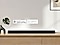 Apple AirPlay logo, Chromecast Built-in logo, and Ok Google logo can be seen along with Samsung Q990B soundbar which is sitting on living room cabinet.