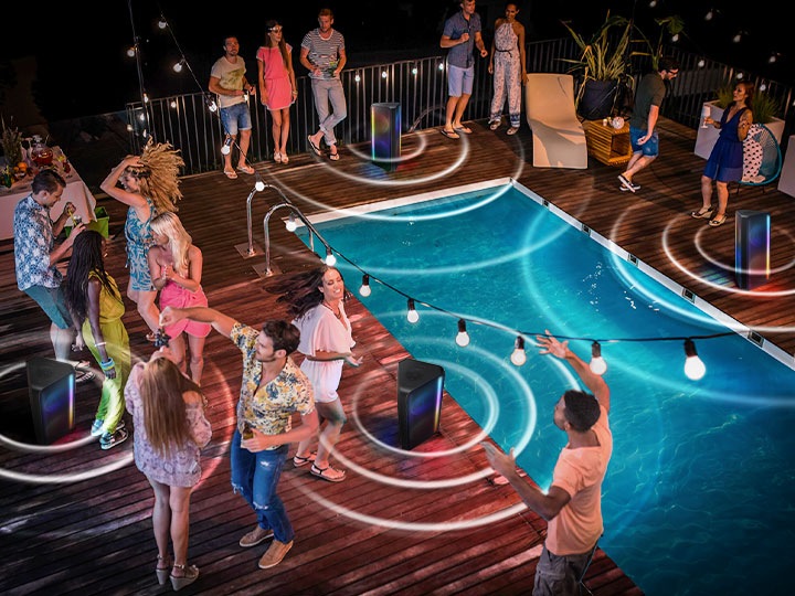 4 Sound Towers are placed in the midst of a pool party with many people.