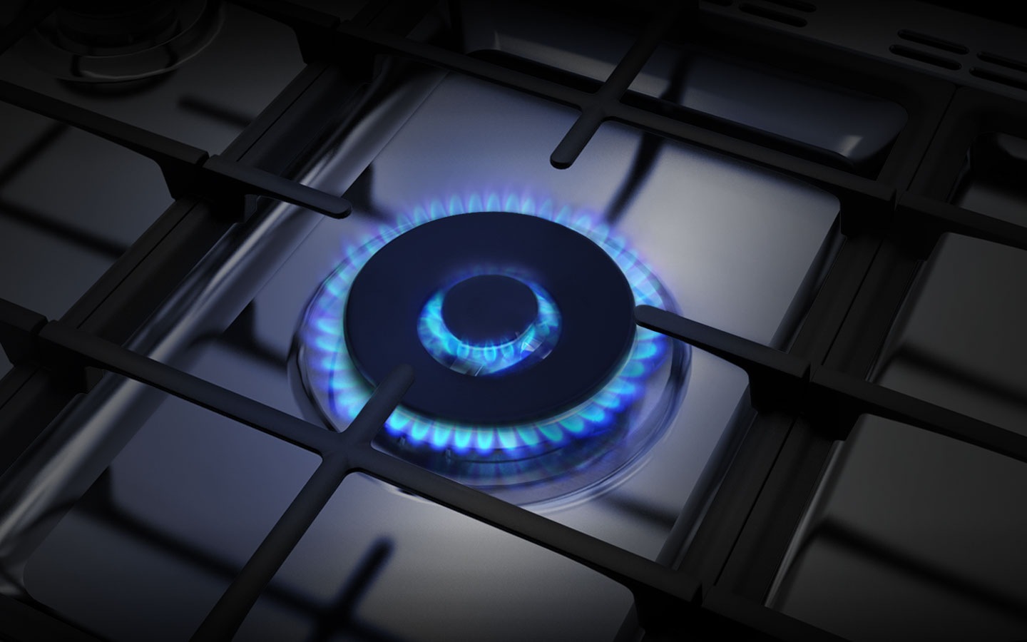 A close-up of the Triple Power Burner shows its three concentric rings of flame.