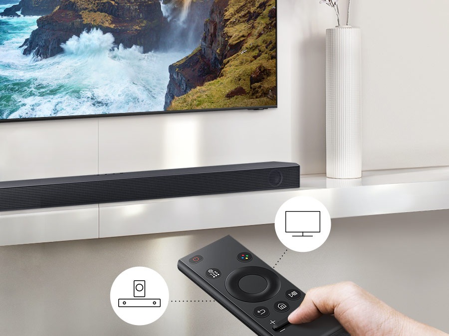 The user controls both Soundbar and TV functions with Samsung TV remote.