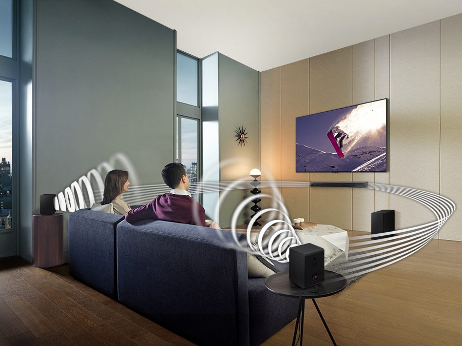 Family watches animation in immersive surround sound with Samsung Wireless Rear Speaker Kit and Soundbar activated together.