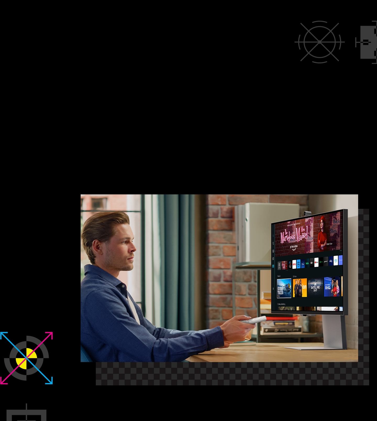 There is a monitor with the media hub UI. In front of the monitor, there is a man holding a remote controller.