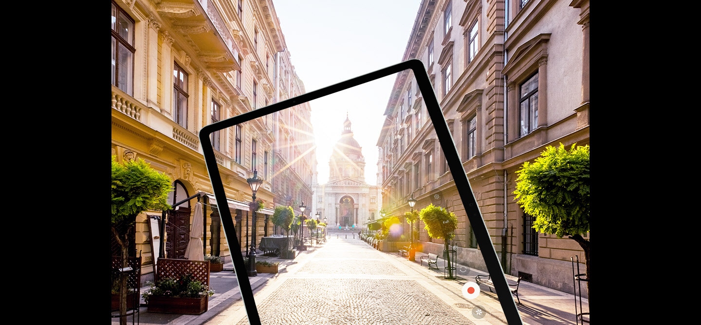 Galaxy Tab S9 FE+ displaying at full screen rays of sunlight over a city street captured by its camera with reduced glare to show a clearer image thanks to Vision Booster.