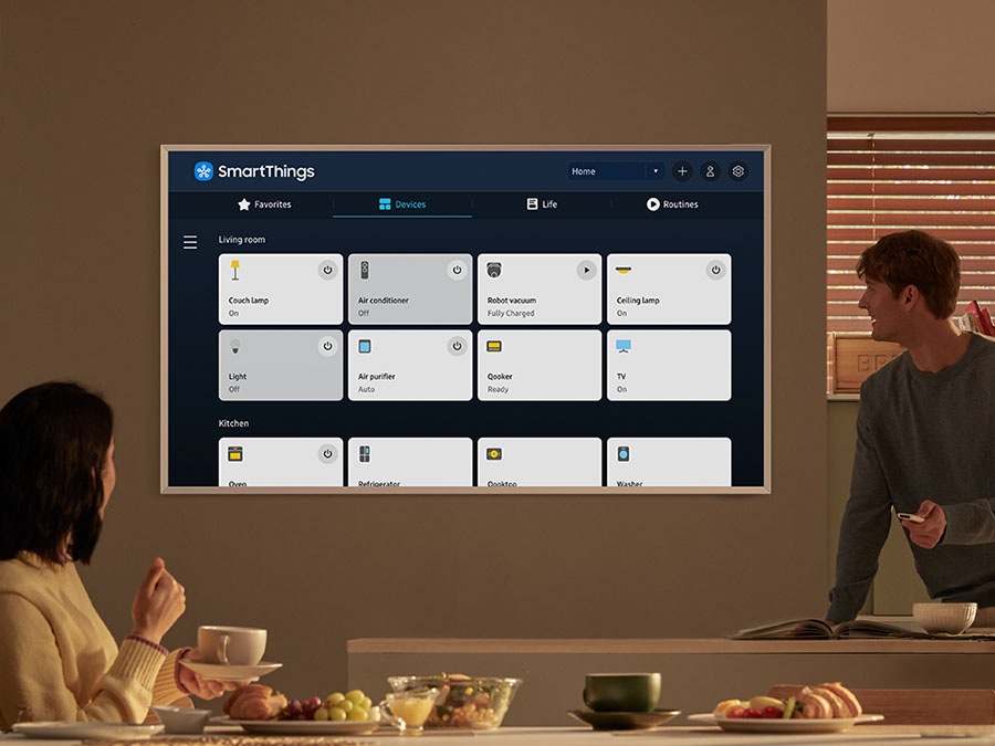The SmartThings UI is on display on the TV. Wi-Fi icons are floating on top of the TV, vacuum robot, air purifier and lights