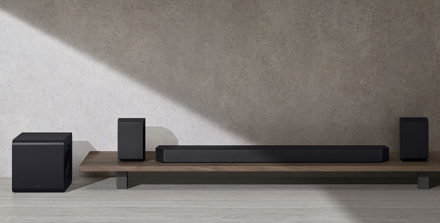 A soundbar, a subwoofer and two rear speakers. Roon Ready logo. TUV Rheinland® Certified Product Carbon Footprint www.tuv.com ID 0217009957 logo. TUV Rheinland® Certified Product Carbon Reduction CO2↓ www.tuv.com ID 0217009945 logo.