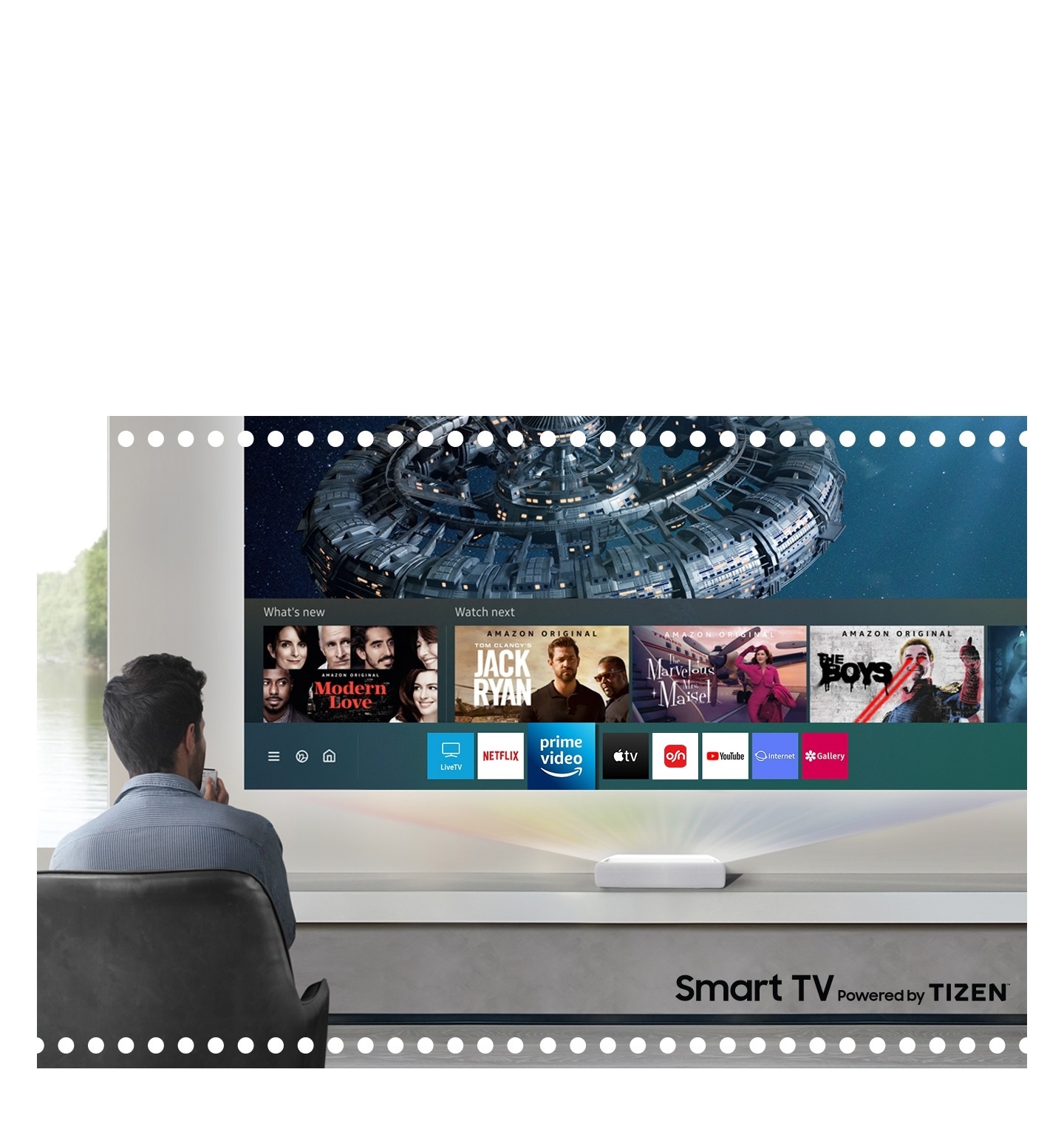 During use The Premiere, a man is considering what to see among the various contents like Samsung Smart TV recommended.