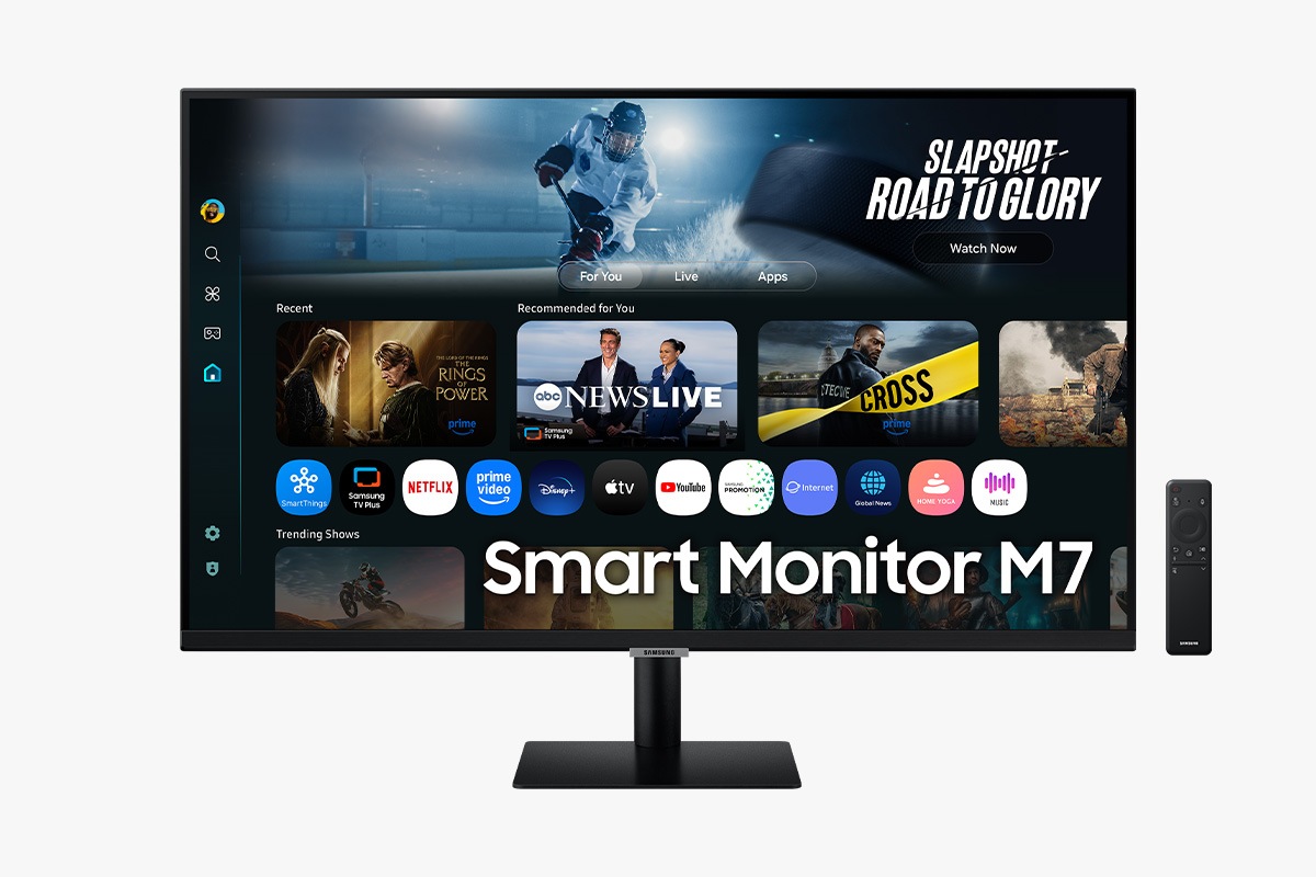 Front of 32 inch Samsung Smart Monitor M7 with the screen showing Smart TV Apps page with various content and apps lined up, and a remote control.