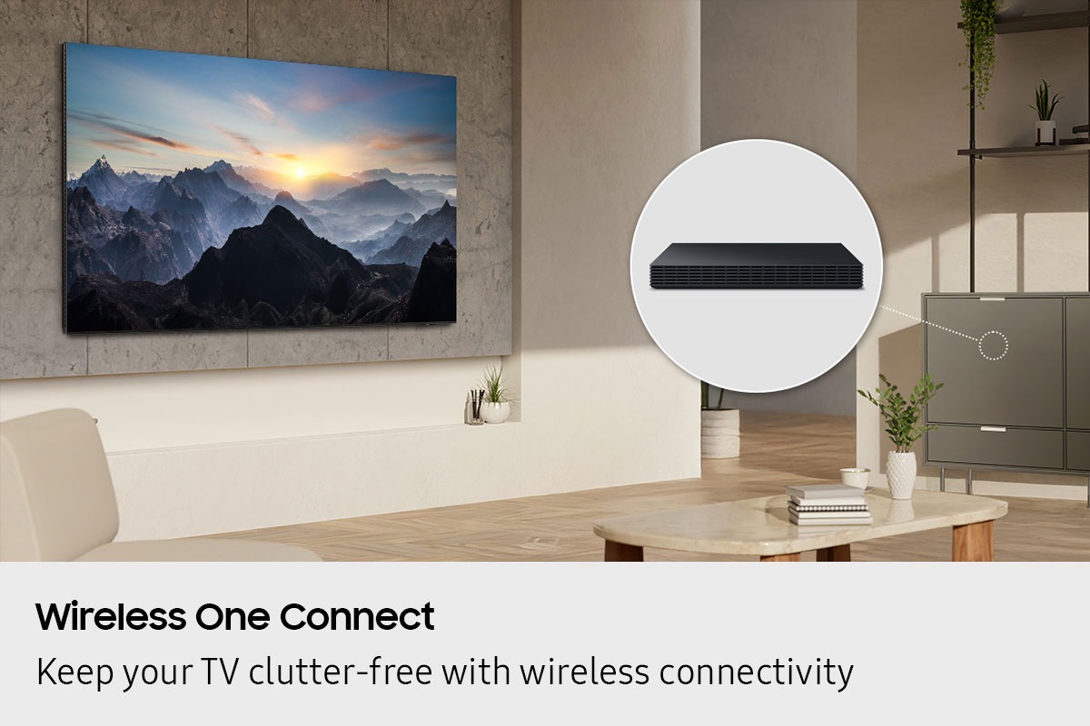 In a living room, a TV is installed cleanly on the wall with no wires. A Wireless One Connect box is hidden inside a cabinet.