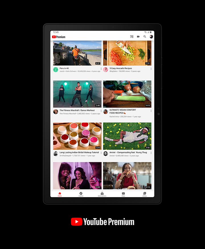 YouTube Premium is open on Galaxy Tab A8. Shown on the screen are thumbnails of various video content: man on a motorcycle, people dancing, women laughing, woman eating, man laying on grass, vegetables on a cutting board, and makeup products.
