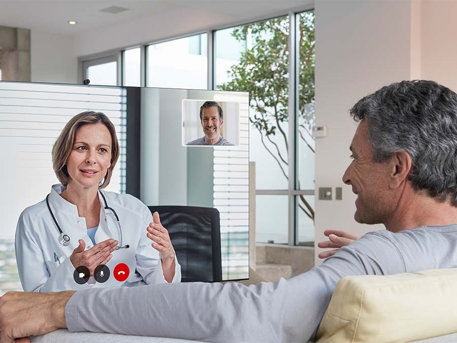 A man is having a consultation with doctor remotely via his TV at home.