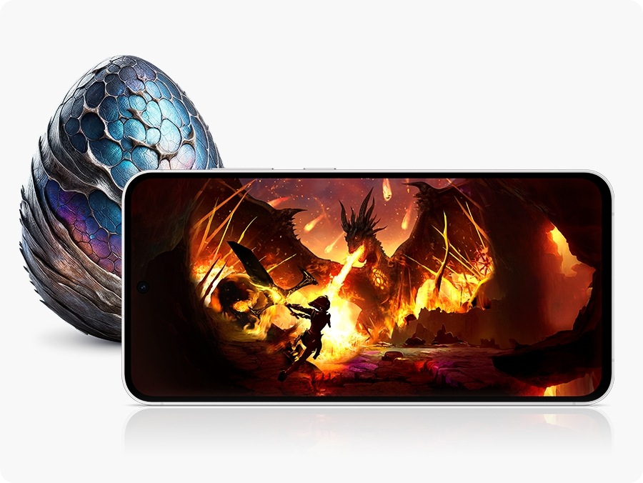 A Galaxy S24 FE device seen from the front and horizontal, displaying a vivid image of a warrior battling a dragon in a fiery setting. Behind the device, there is a dragon-like egg with blue and purple scales.