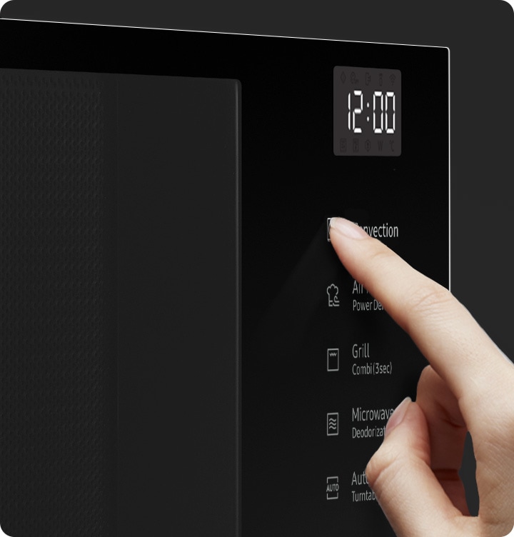 A person touches a button on the glass touch control panel.