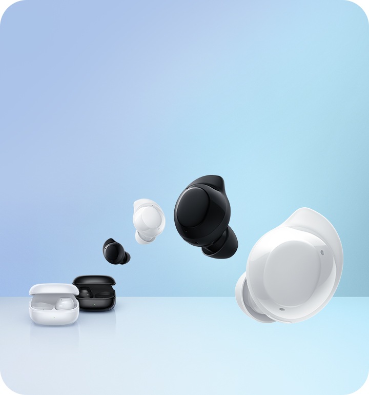 The white Galaxy Buds Core charging case is in front of the black Galaxy Buds Core charging case. Overhead are four Galaxy Buds Core earbuds arranged in alternating black and white colors in the following order black, white, black, white.