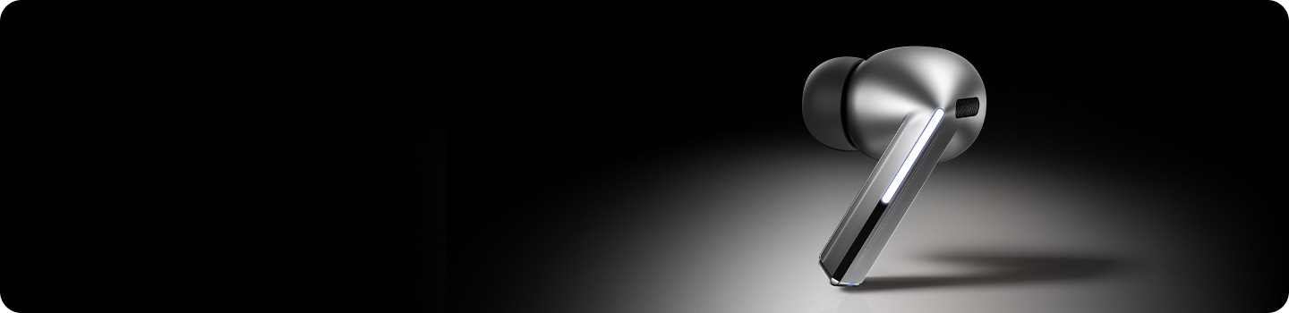 A single, silver colored Galaxy Buds3 Pro earbud with the Blade Light on.