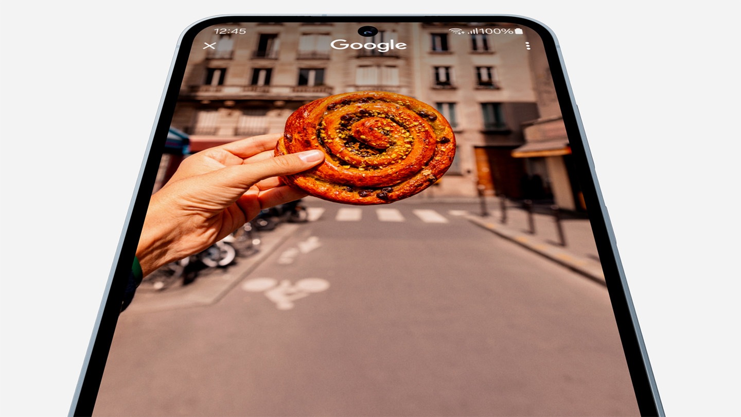 A Galaxy A55 5G device showing a pastry on-screen moves to the center of the frame while the pastry is circled to reveal Google search results on the pastry pop up at the bottom.