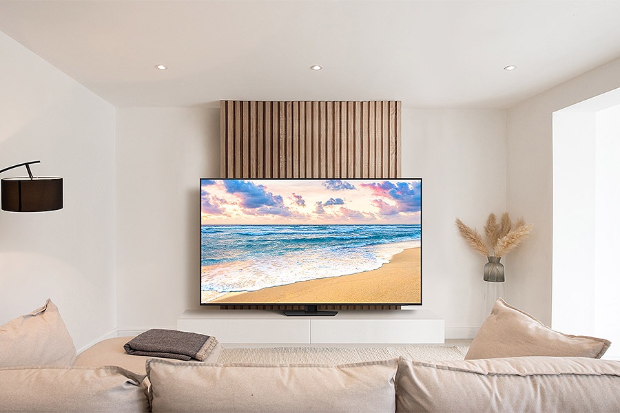 QN85D is placed beautifully on top of a console in a simple white living room.