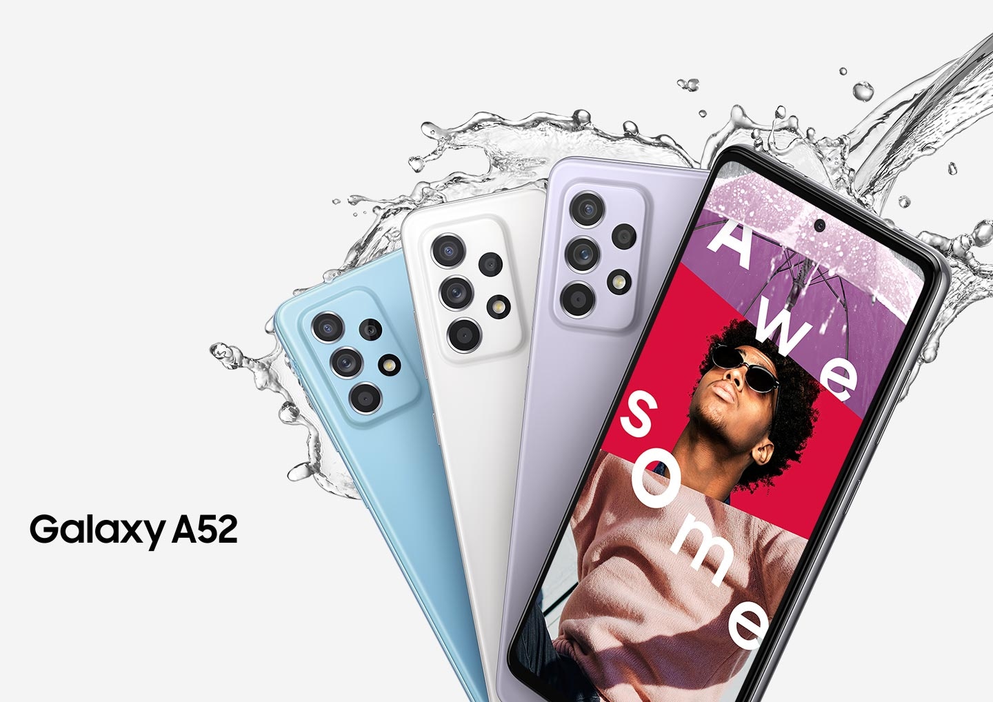 Quatre téléphones Galaxy A52 en éventail. Trois vus de dos pour montrer l’appareil photo arrière et les couleurs Bleu Magistral, Blanc Magistral et Violet Magistral. L’un vu de face, avec à l’écran un collage d’un parapluie transparent et d’un homme portant des lunettes de soleil et un sweat couleur pêche, avec le mot Magistral. De l’eau éclabousse les téléphones.