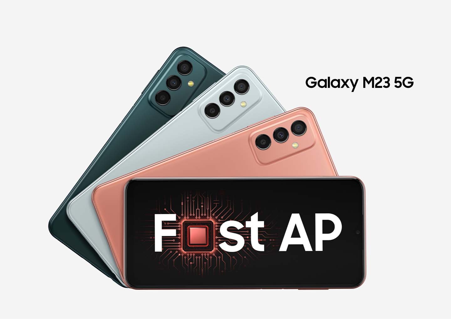Four Galaxy M23 5G devices are placed in layers of descending angles to show different colorways of Deep Green, Light Blue and Orange Copper. The Galaxy M23 5G on the bottom shows the front with on-screen text readings Fast AP with the a in Fast replaced with a processing chip.