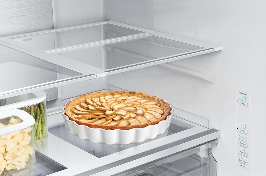 There is an arrow indicating that the shelf of the RF6500C slides half the width into the refrigerator. So you can store not only pie also tall bottles on the shelf.