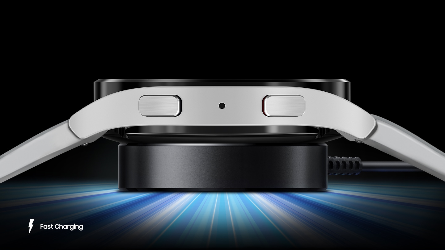 A side view of the Galaxy Watch5 charging with blue lights emitting from the charger to depict speed.