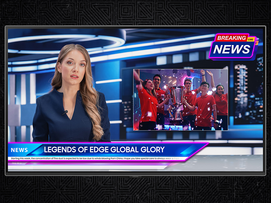 A newscaster sits at a desk, reporting on a breaking news story. A badge saying "Breaking News" is in the top right, with a  lower third saying "Legends of Edge Global Glory." A screen with a scene of a winning sports team is to the right of the newscaster.