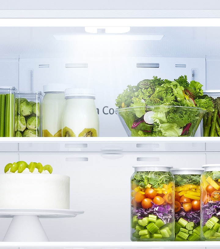 All the doors of the RF5000A are open, while LED lighting illuminates the food in the fridge and freezer chambers.