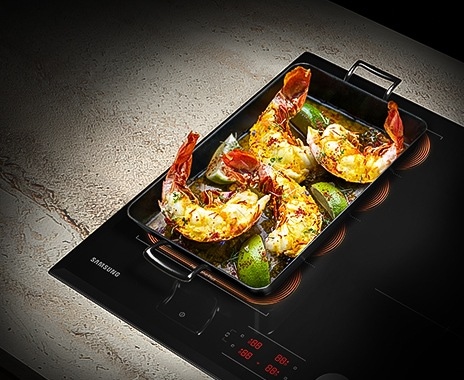 A rectangle pan with shrimps and limes is on the Flex Zone Plus.