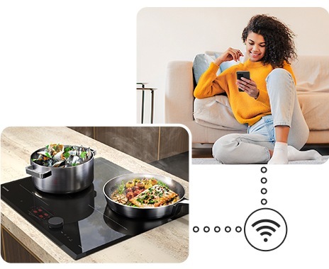 Two pots with delicious food are boiling on the cooktop, and a woman is monitoring the cooktop status remotely near the sofa via the SmartThings app on her smartphone.
