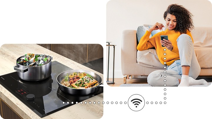 Two pots with delicious food are boiling on the cooktop, and a woman is monitoring the cooktop status remotely near the sofa via the SmartThings app on her smartphone.
