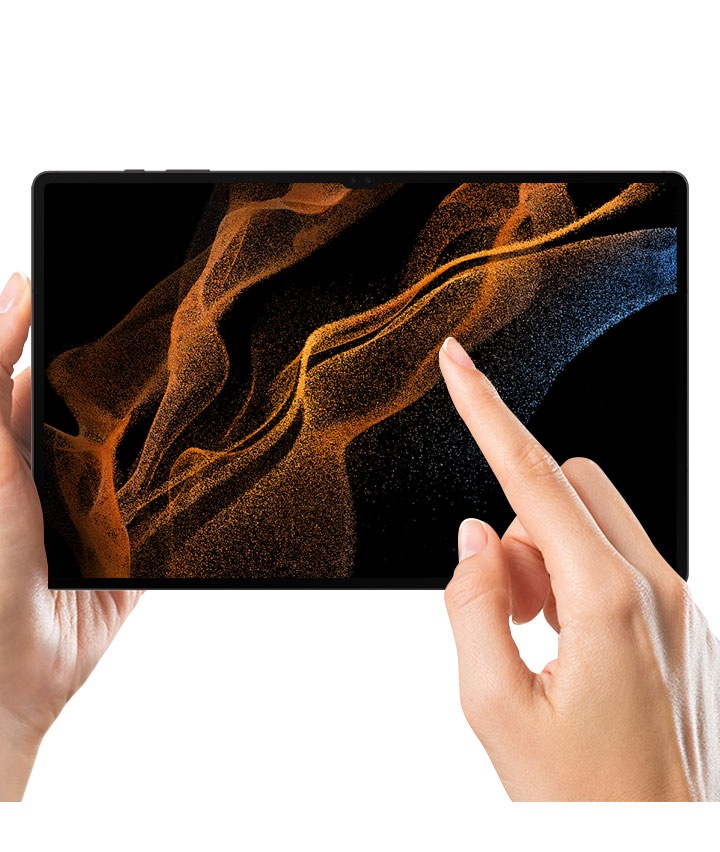 A person holds a Galaxy Tab S8 Ultra with the screen protector film on in their left hand. A right index finger touches the screen.