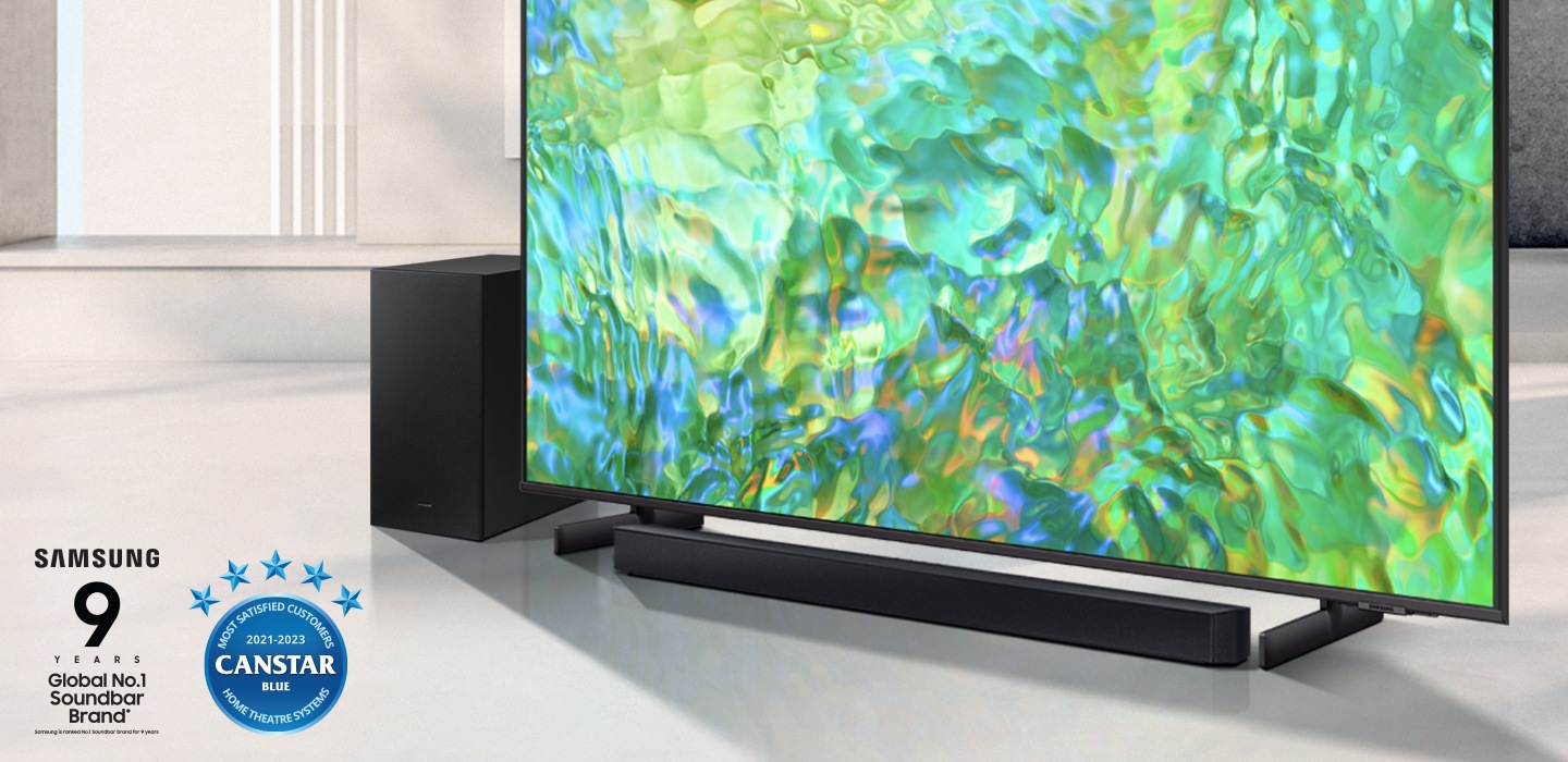 Samsung C series Soundbar and subwoofer are positioned with Samsung Smart TV.