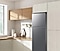 The sleek exterior of the fridge gives a clean look to the modern kitchen, with a flat finish.