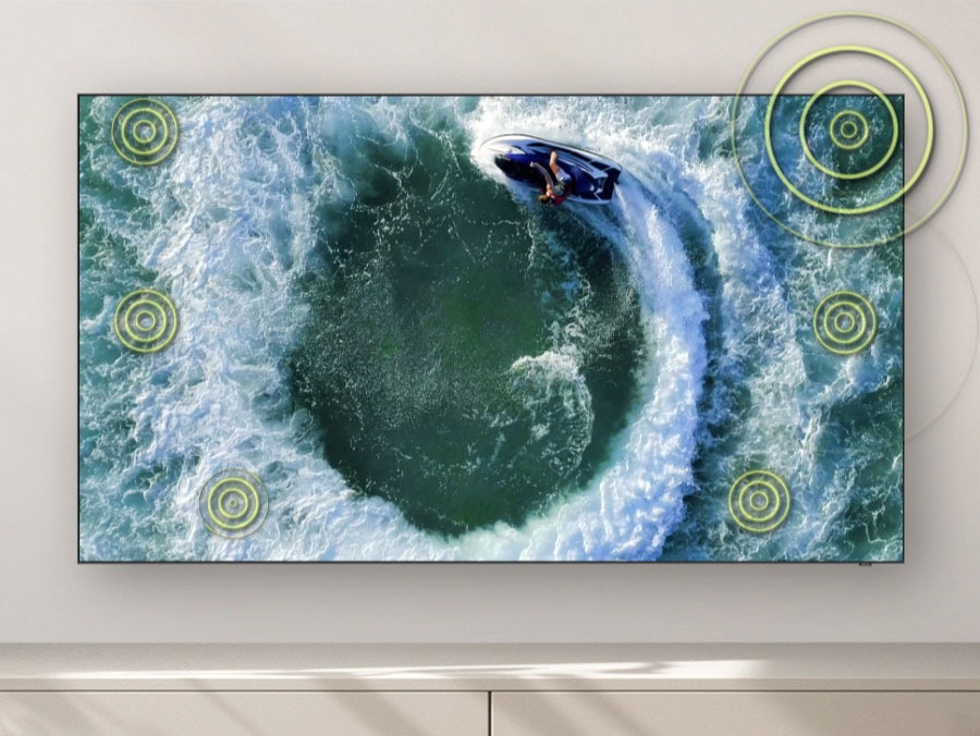 The image shows a men surfing on the sea to let user enjoy captivating sound that uses eight strategically positioned speakers to track motion on screen.