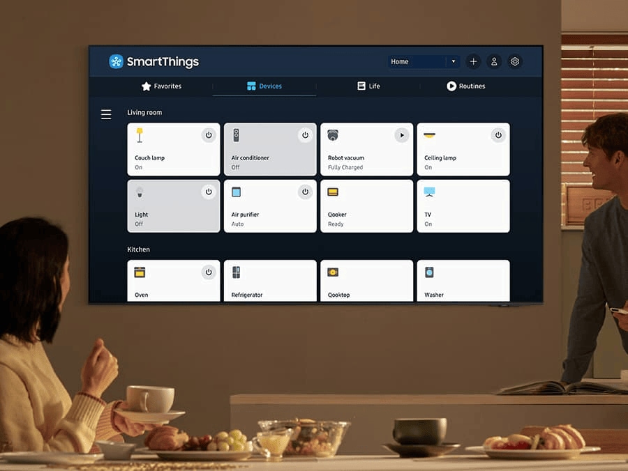 This image shows a woman and a man are in a room to watch SmartThings screen on Samsung TV.