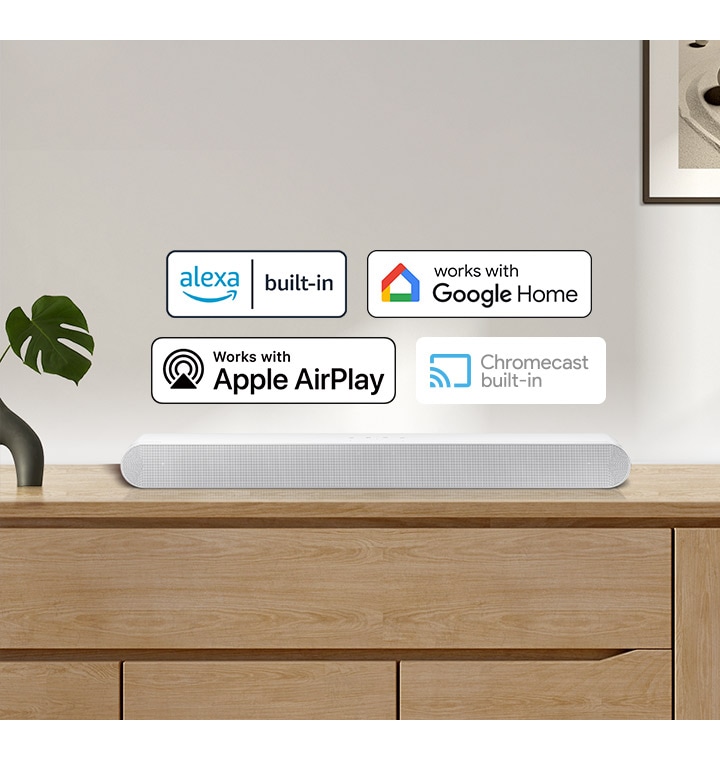 A Samsung Soundbar with logos for Alexa built-in, Works with Google Home, Works with Apple AirPlay and Chromecast built-in.