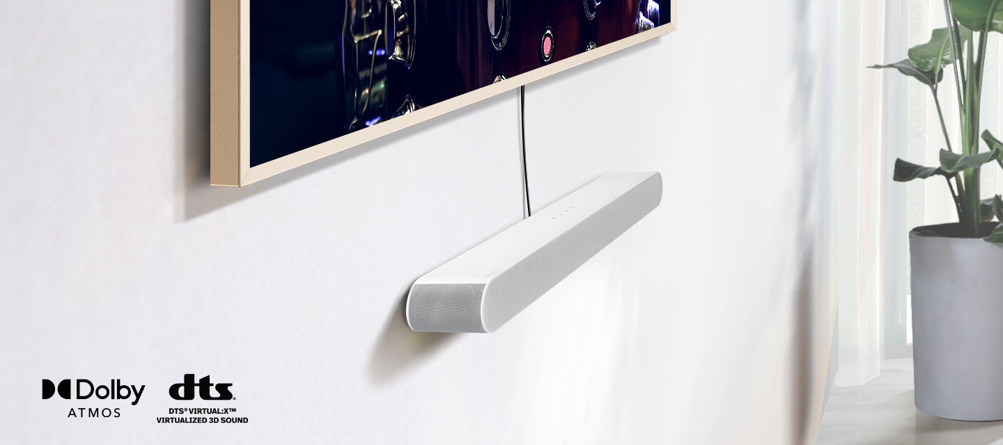 A close-up on a Samsung Soundbar installed underneath a TV, along with the logos for Dolby Atmos and DTS Virtual:X. A Wi-Fi signal icon pops up near the Soundbar. The scene zooms out to reveal an entire living room. The Soundbar gives off a series of round sound waves.
