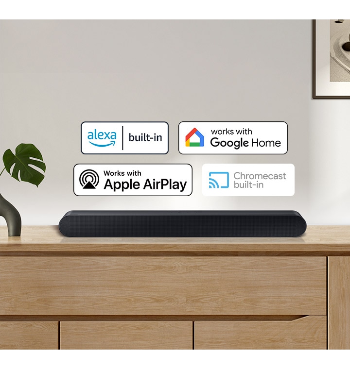 A Samsung Soundbar with logos for Alexa built-in, Works with Google Home, Works with Apple AirPlay and Chromecast built-in.